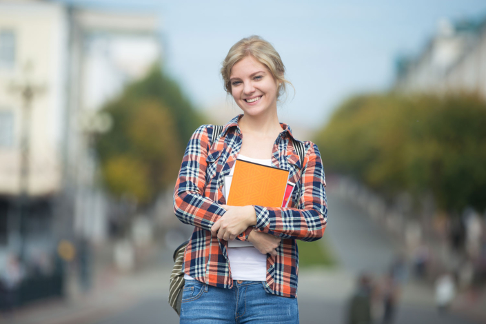 portrait-young-attractive-student-girl-against-blurred-city-street